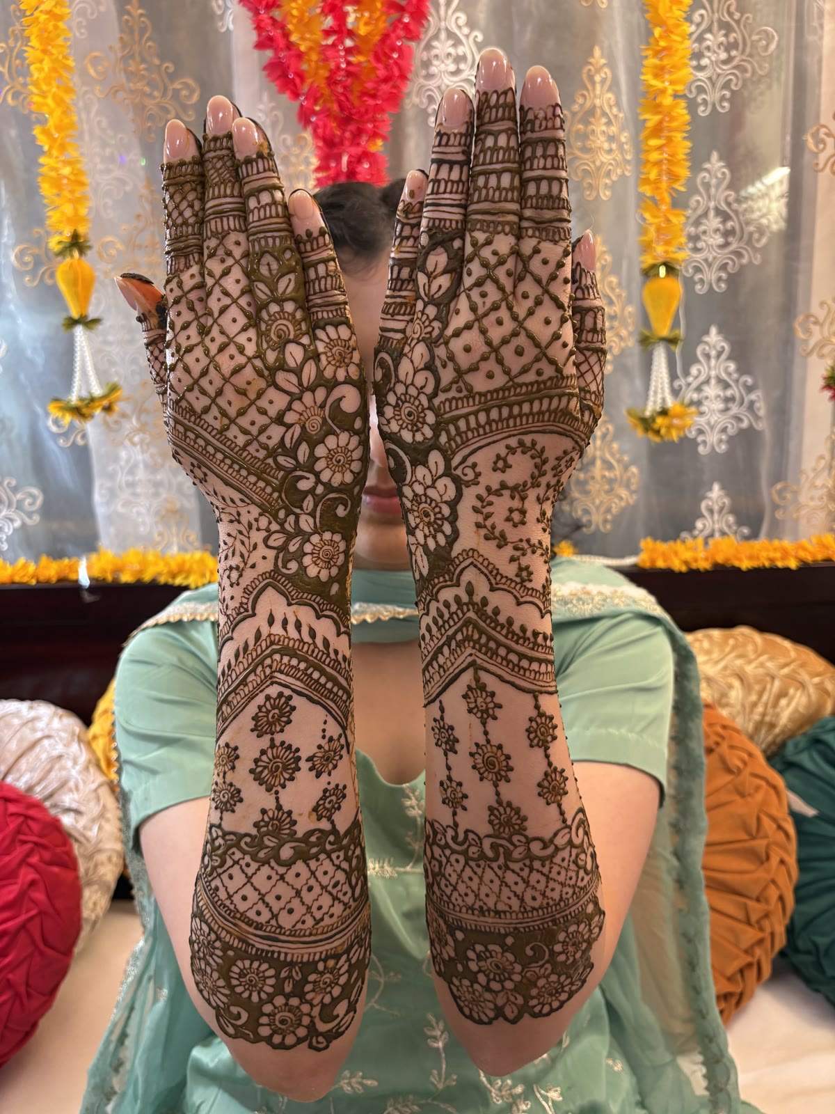 Bridal henna on hands with lotus flowers and crosshatch patterns