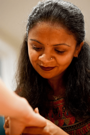 Avani Henna artist applying mehndi at corporate event in Seattle